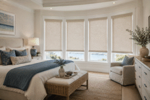 A bedroom proves blackout shades can be stylish with cream colored shades.