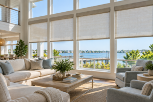 A living room in a coastal home uses shades for light control and privacy.